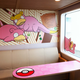 A wall, a table, and a window inside the ferry that are covered with Slowpokes.
